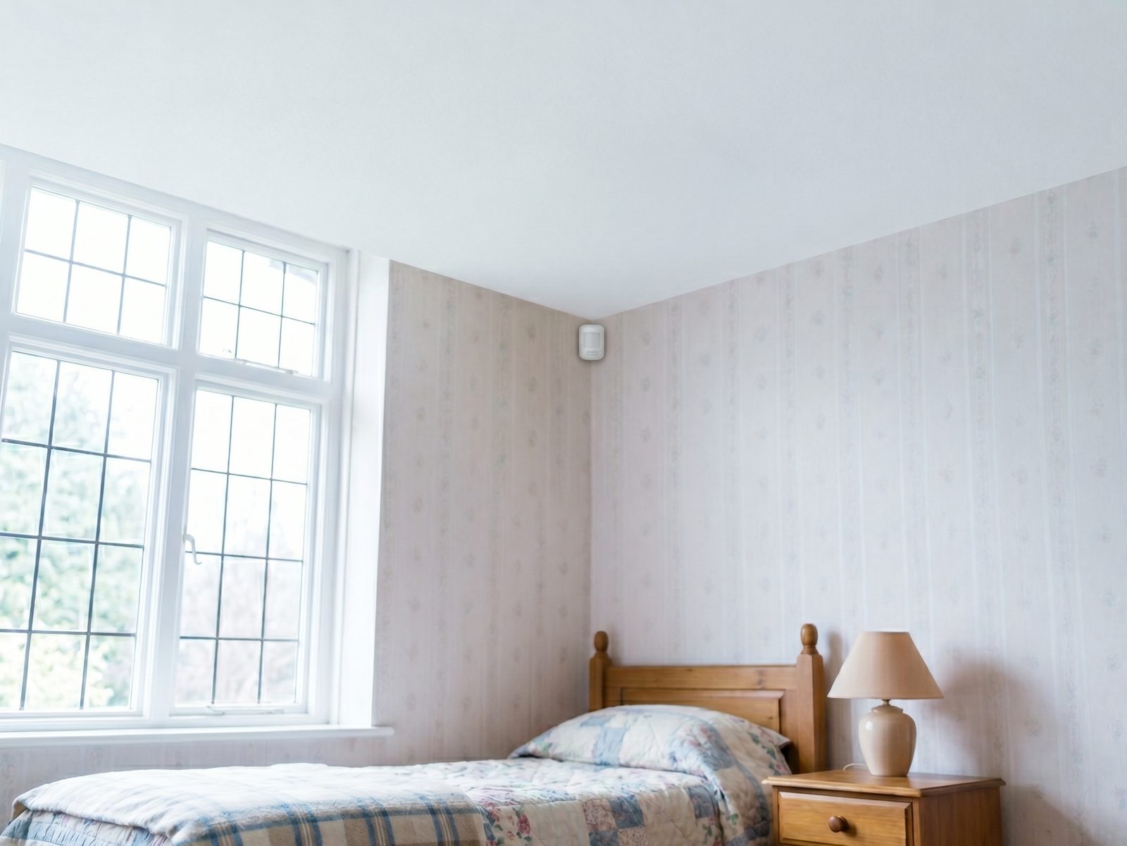 A bright resident room with a single small Vistarra sensor mounted high in the corner